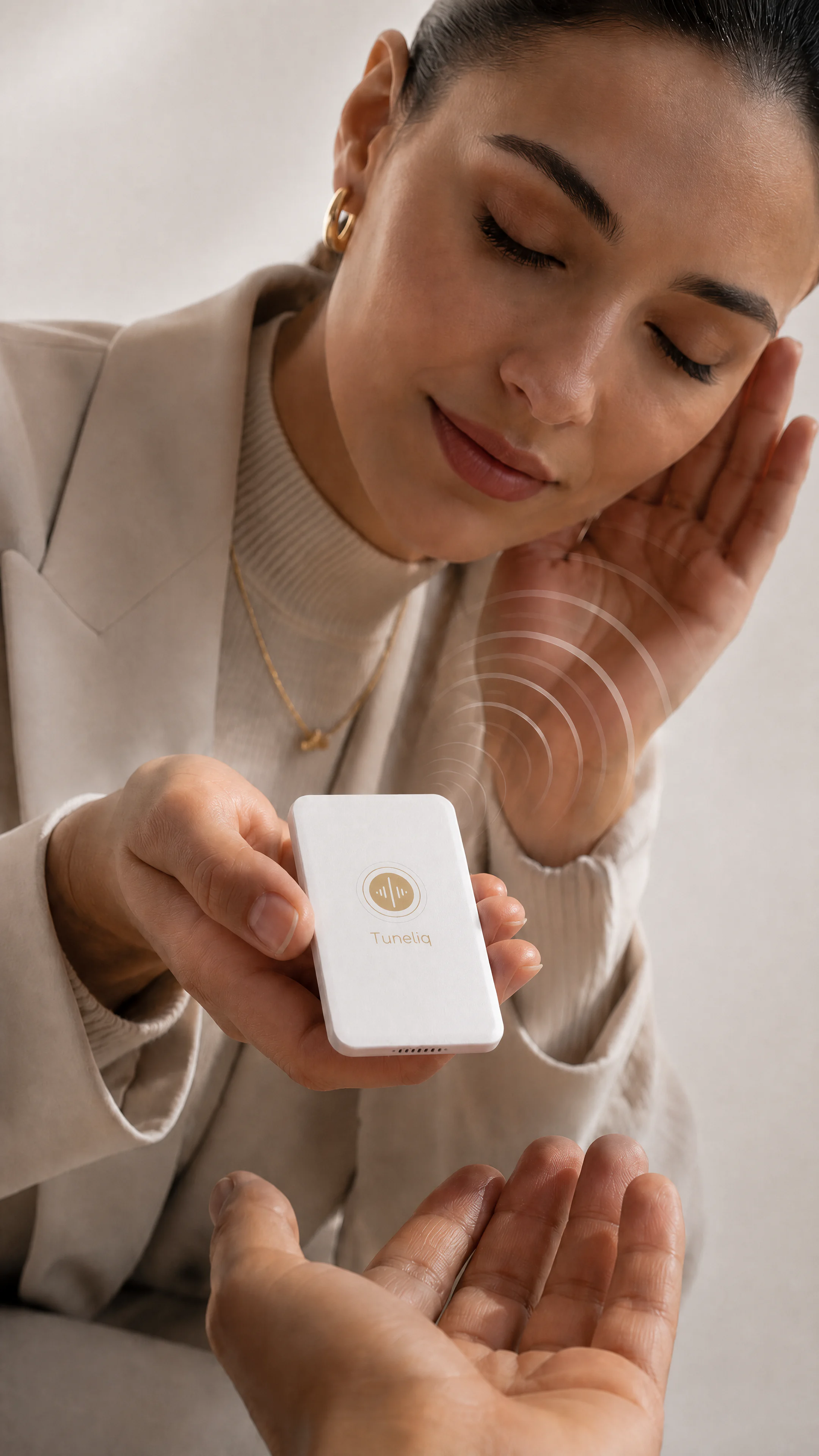 A woman holding Tuneliq Card close and listening to its song